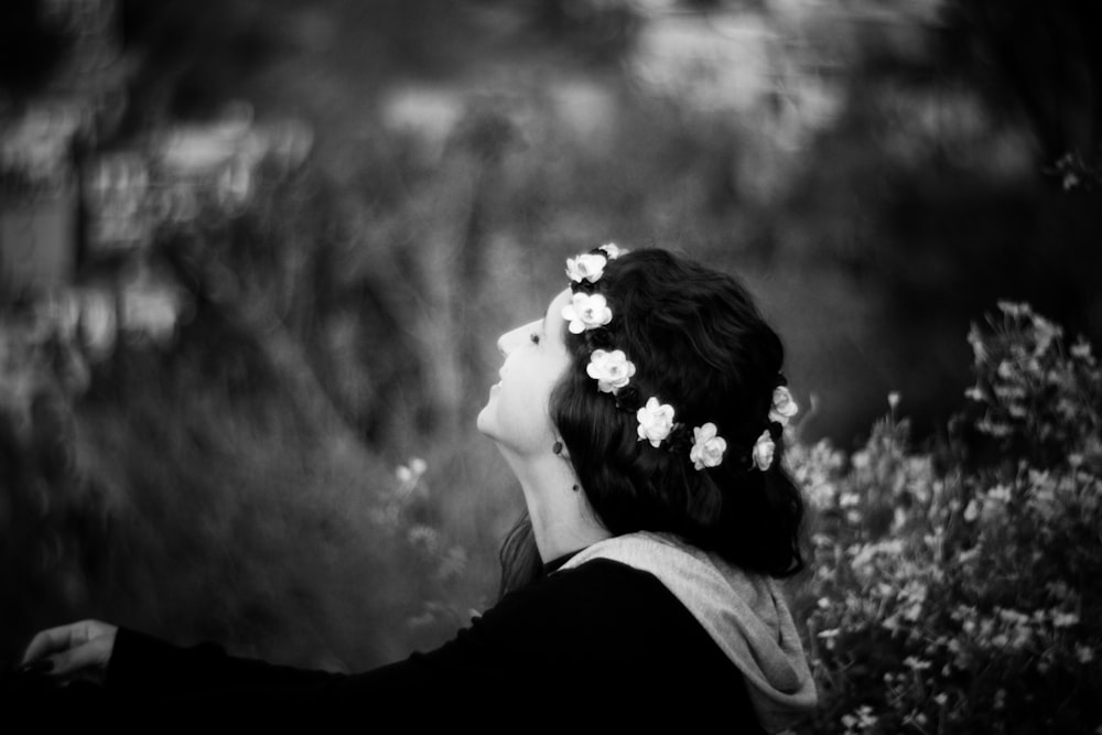 grayscale photograph of woman in garden