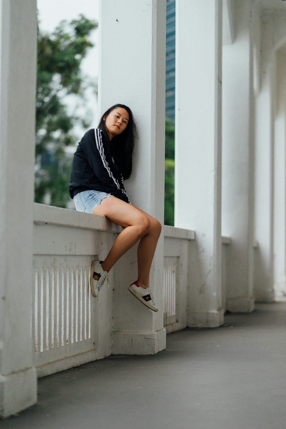 woman sitting on handrail