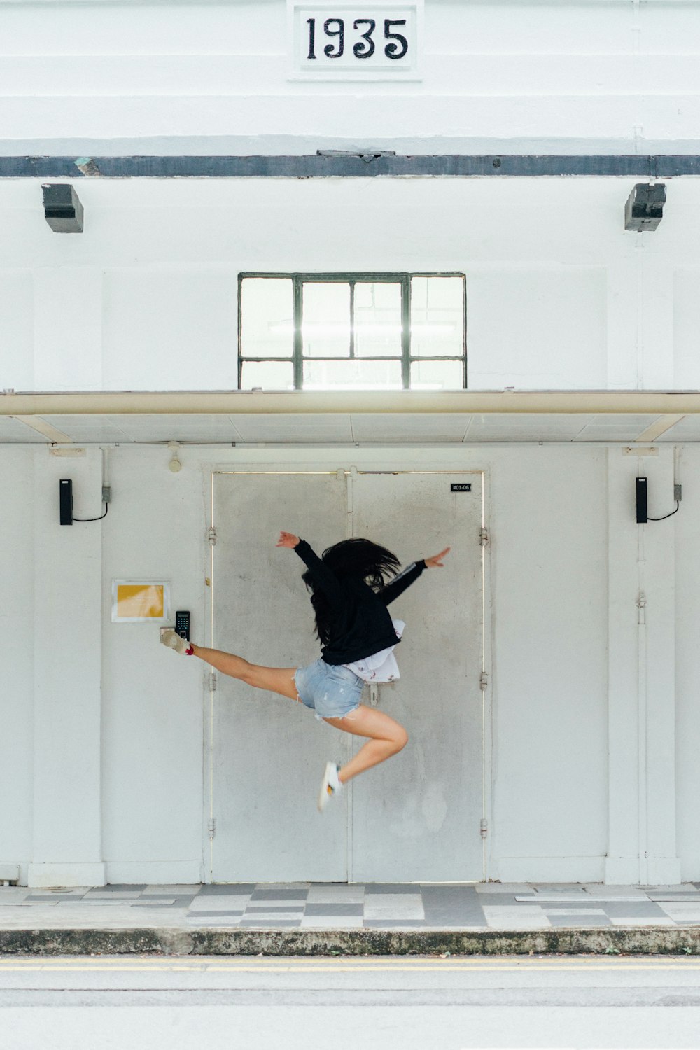 woman jumping in front of door