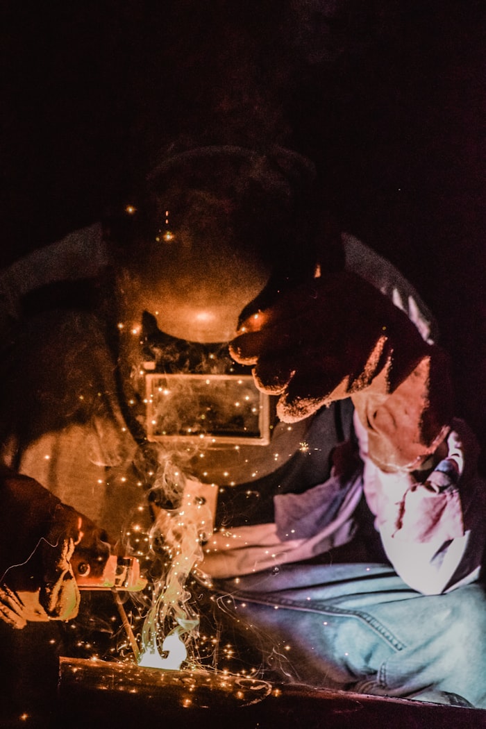 Person welding metal component