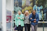two women and man walking in the street during daytime