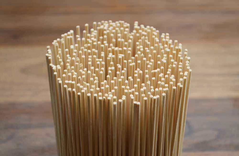stack of uncooked pasta near wood