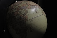 A detailed 3D cartoon of a globe highlighting global market trends.