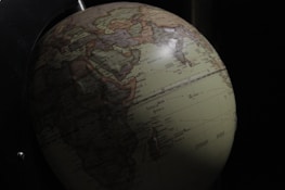 A globe with flight routes connecting various countries.