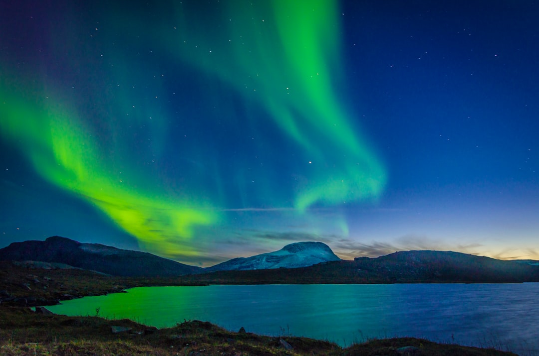 aurora borealis over body of water during nighttime
