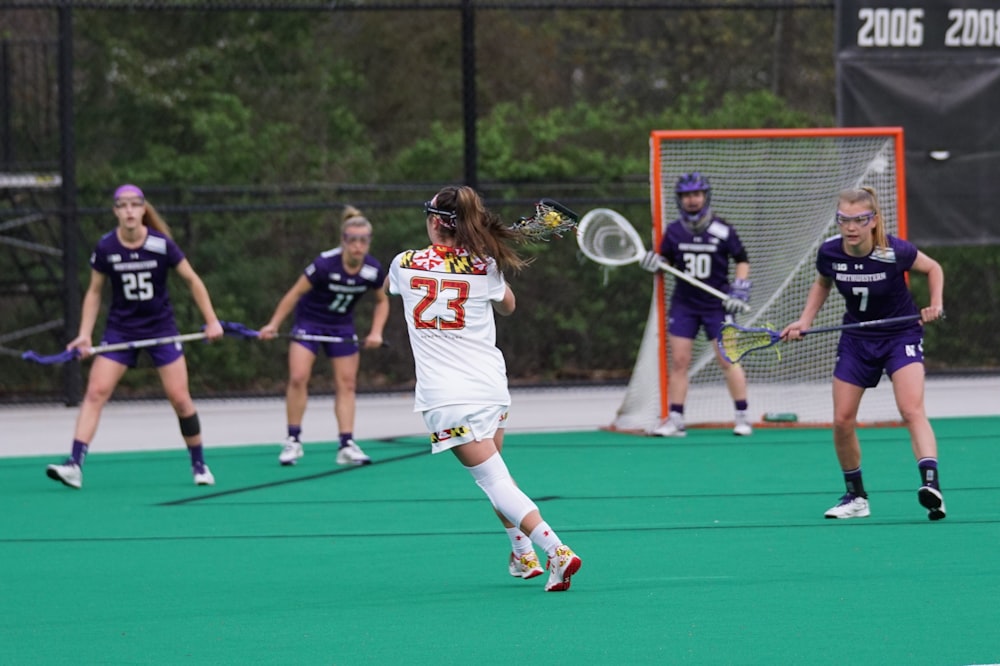 girls playing lacrosse game