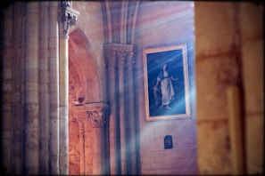 Natural light illuminating a detailed landscape painting on canvas