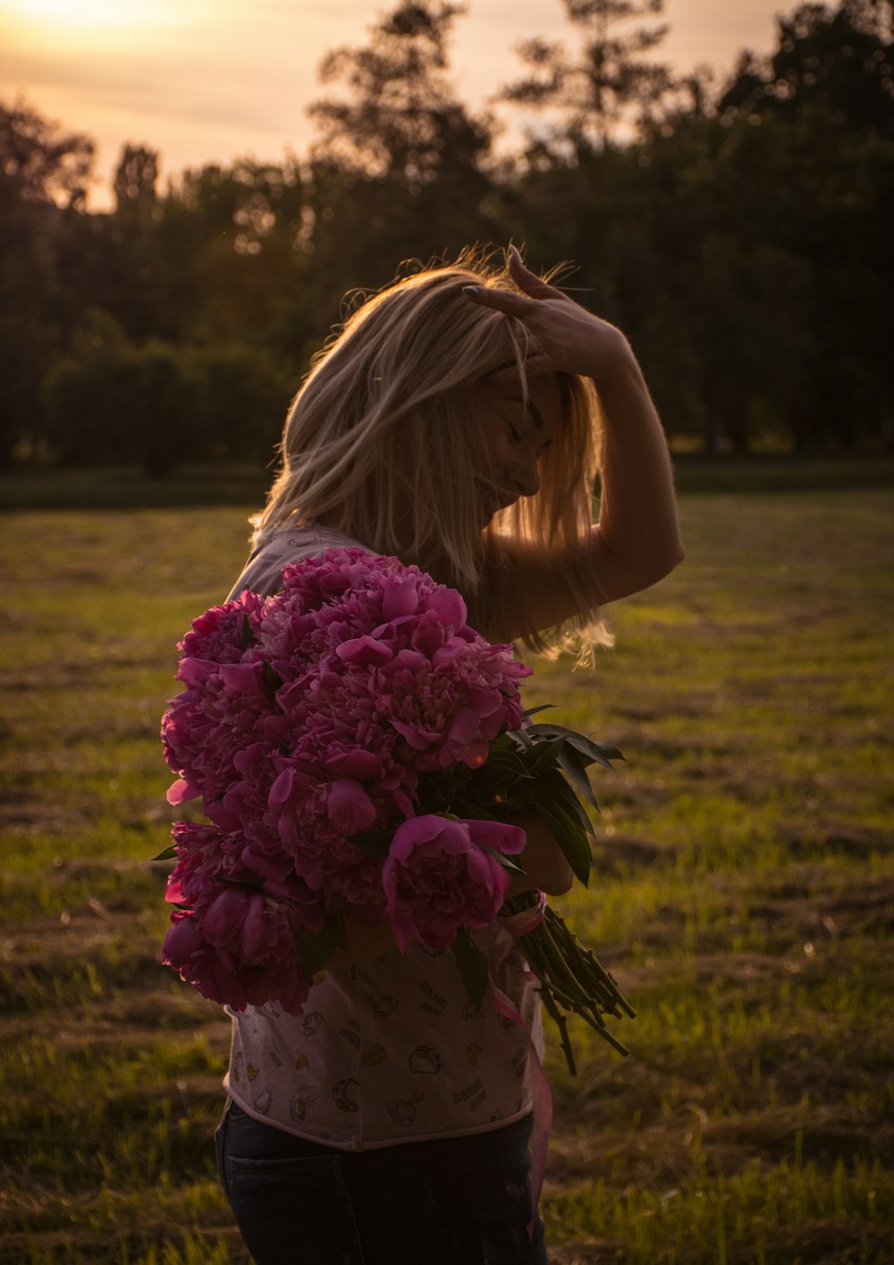 woman standing holding bouquet of flower