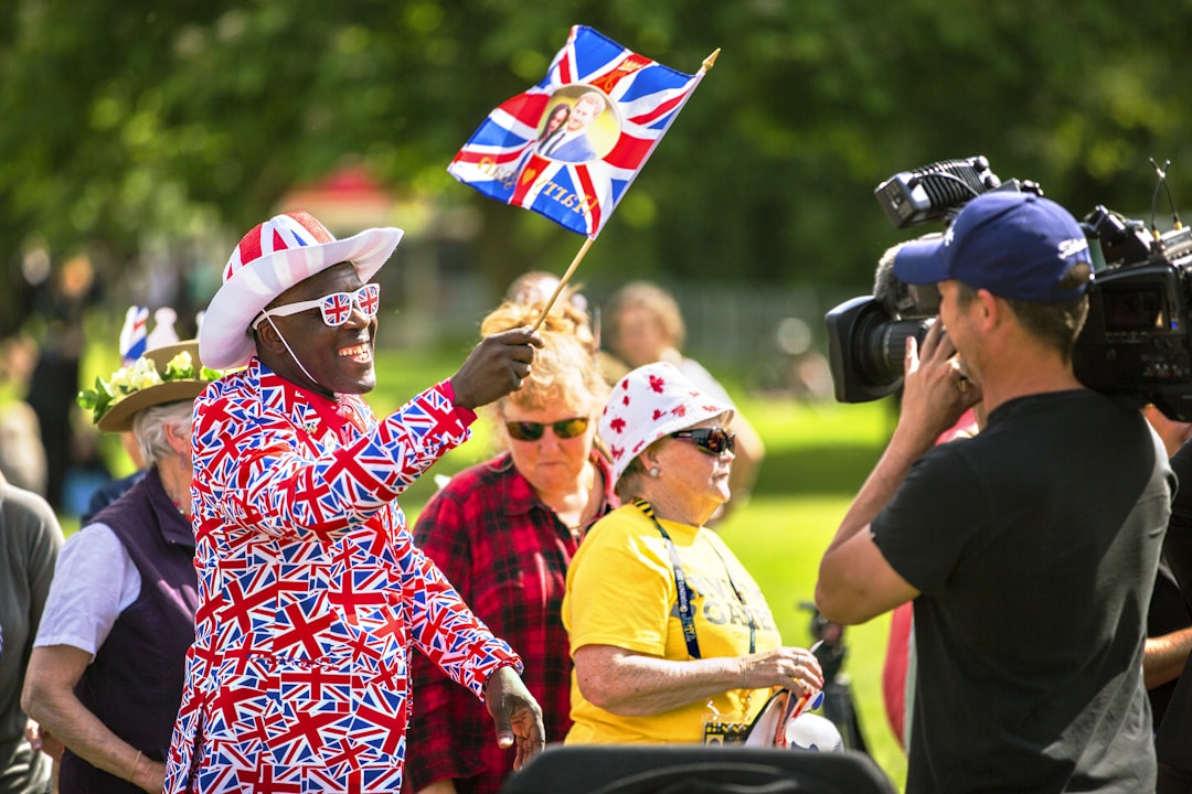 man holding flag, Crowds converging on Windsor to celebrate the Royal Wedding of Prince Harry and Meghan Markle.