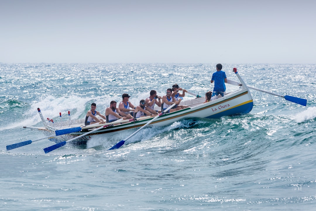 group of men riding boat, Regata de las 3 Millas, celebrada en las Playas de El Palo de Málaga el 09-09-2017. Se levantó un fuerte temporal de levante y algunas pruebas se suspendieron. Esta tripulación y su patrón supieron “capear el temporal” de manera envidiable.