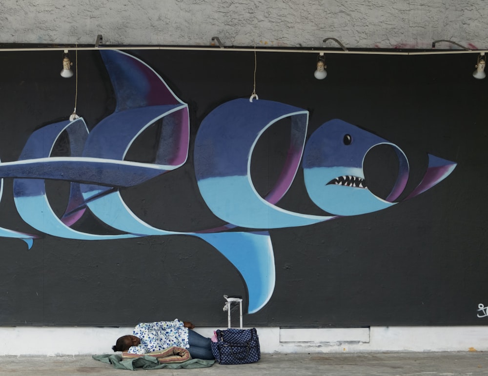 a mural of a shark on the side of a building