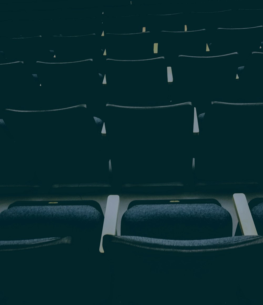 unfolded empty theater chairs