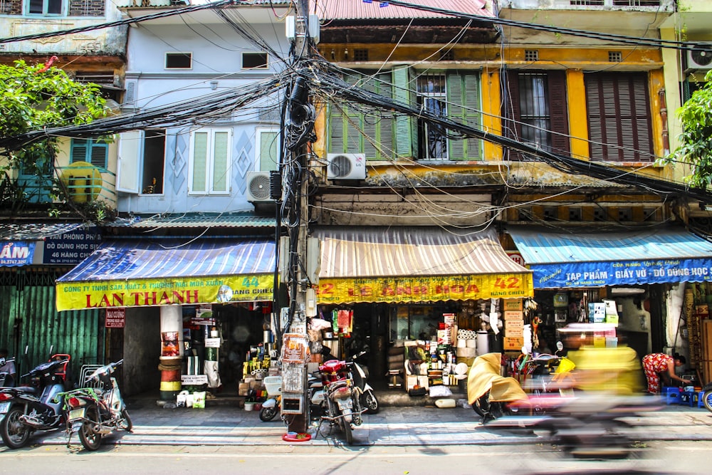 panning photography of black motorcycle beside store