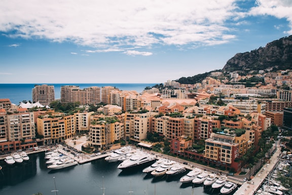 aerial photography of docks yachts near buildings