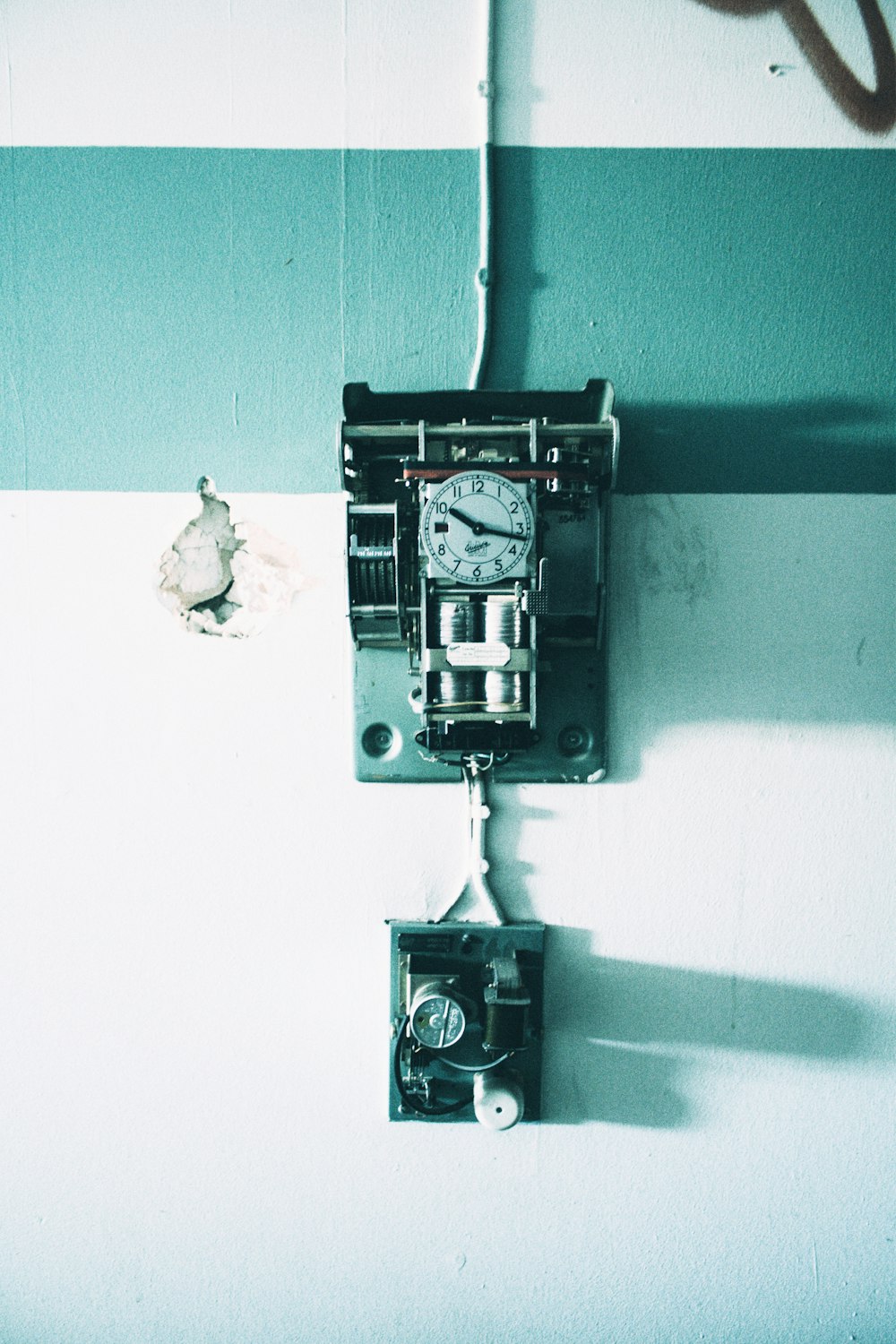 relógio analógico de parede preto e cinza pendurado na parede