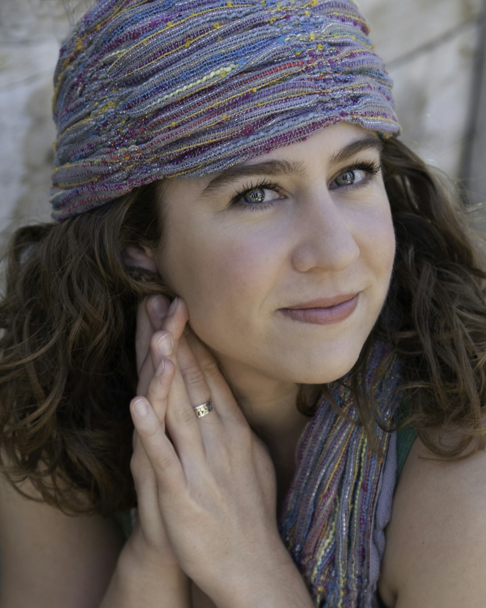 woman wearing headdress holding both arms