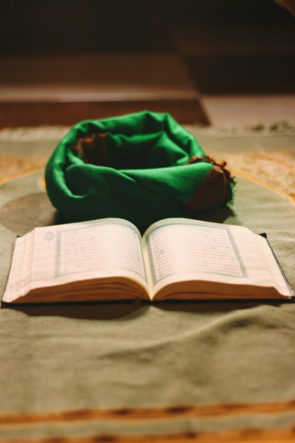 white book beside green textile