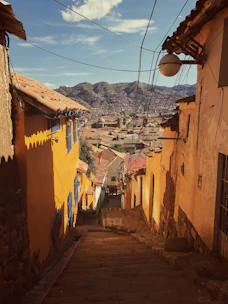 orange houses near green mountain