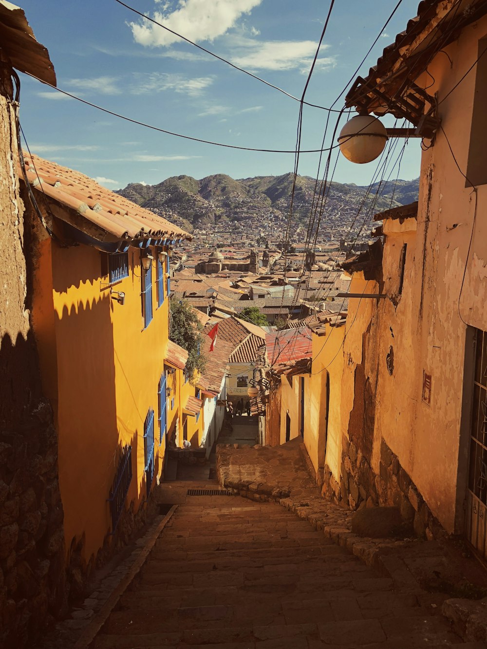 orange houses near green mountain