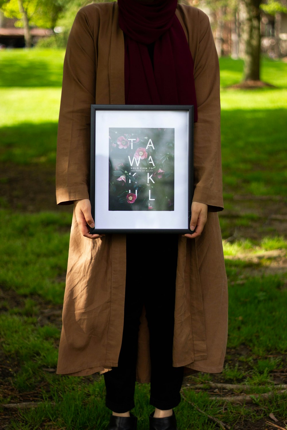 woman holding black photo frame