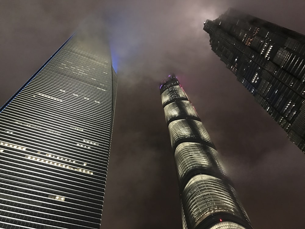 low angle photography of three high rise buildings