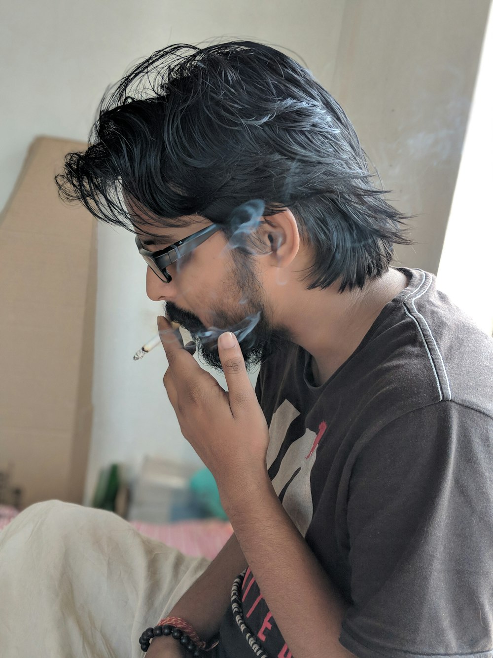 man sitting and smoking inside room