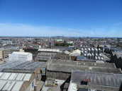 A panoramic view of Arraiján’s industrial zone under a clear blue sky with golden sunlight.