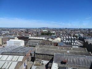 A panoramic view of modern industrial facilities and commercial buildings under a clear sky.