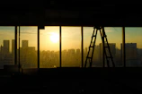 Large window with city skyline view at sunset.