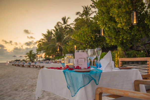 A beautifully set coastal party table with elegant decorations inspired by ocean waves.