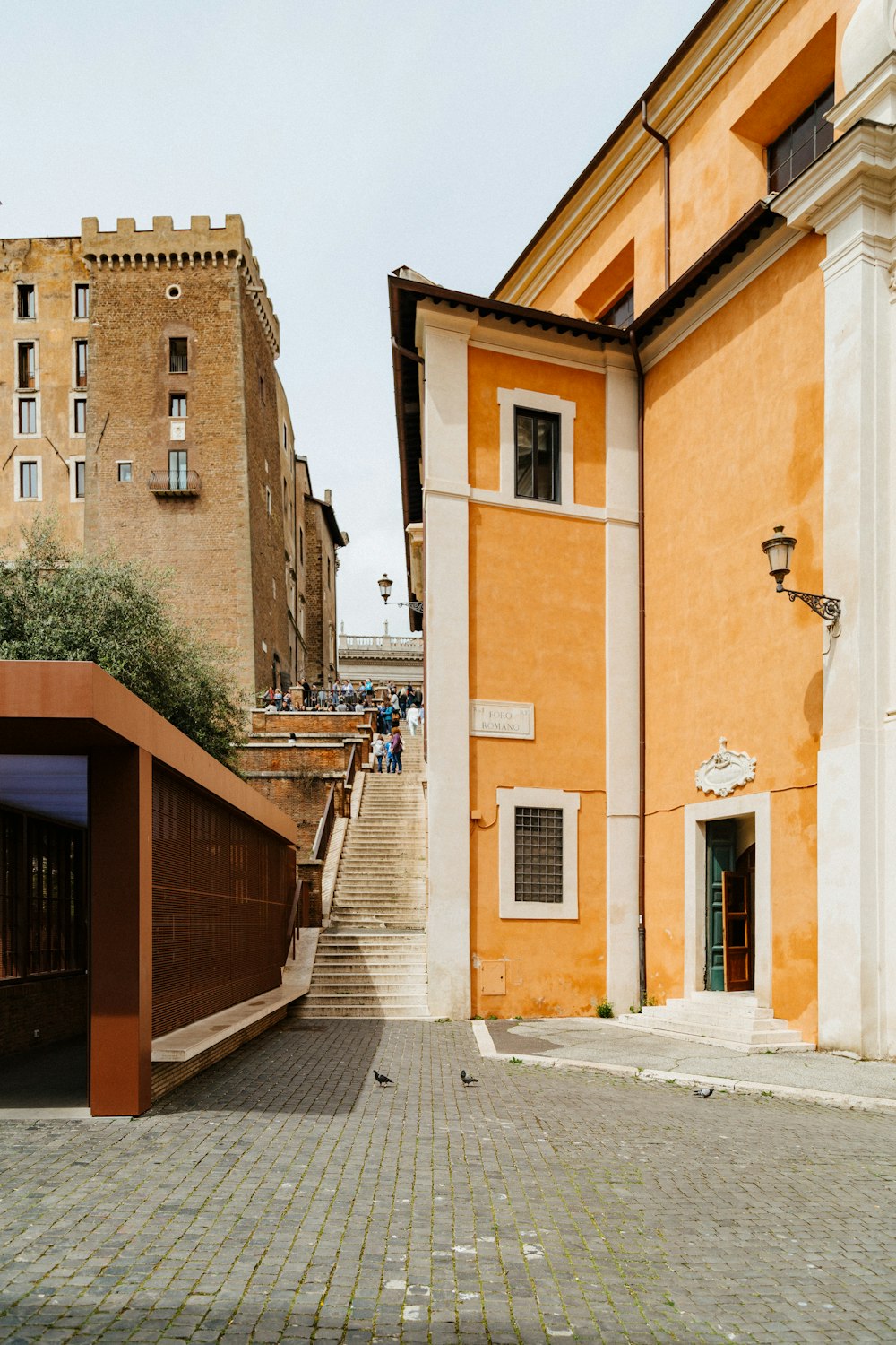 orange and white buildings with stairs in middle