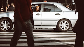 man sitting inside car on street during daytime