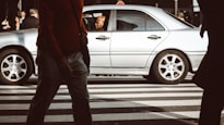 man sitting inside car on street during daytime