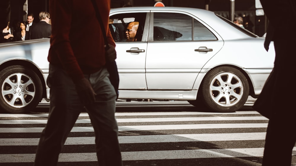 man sitting inside car on street during daytime