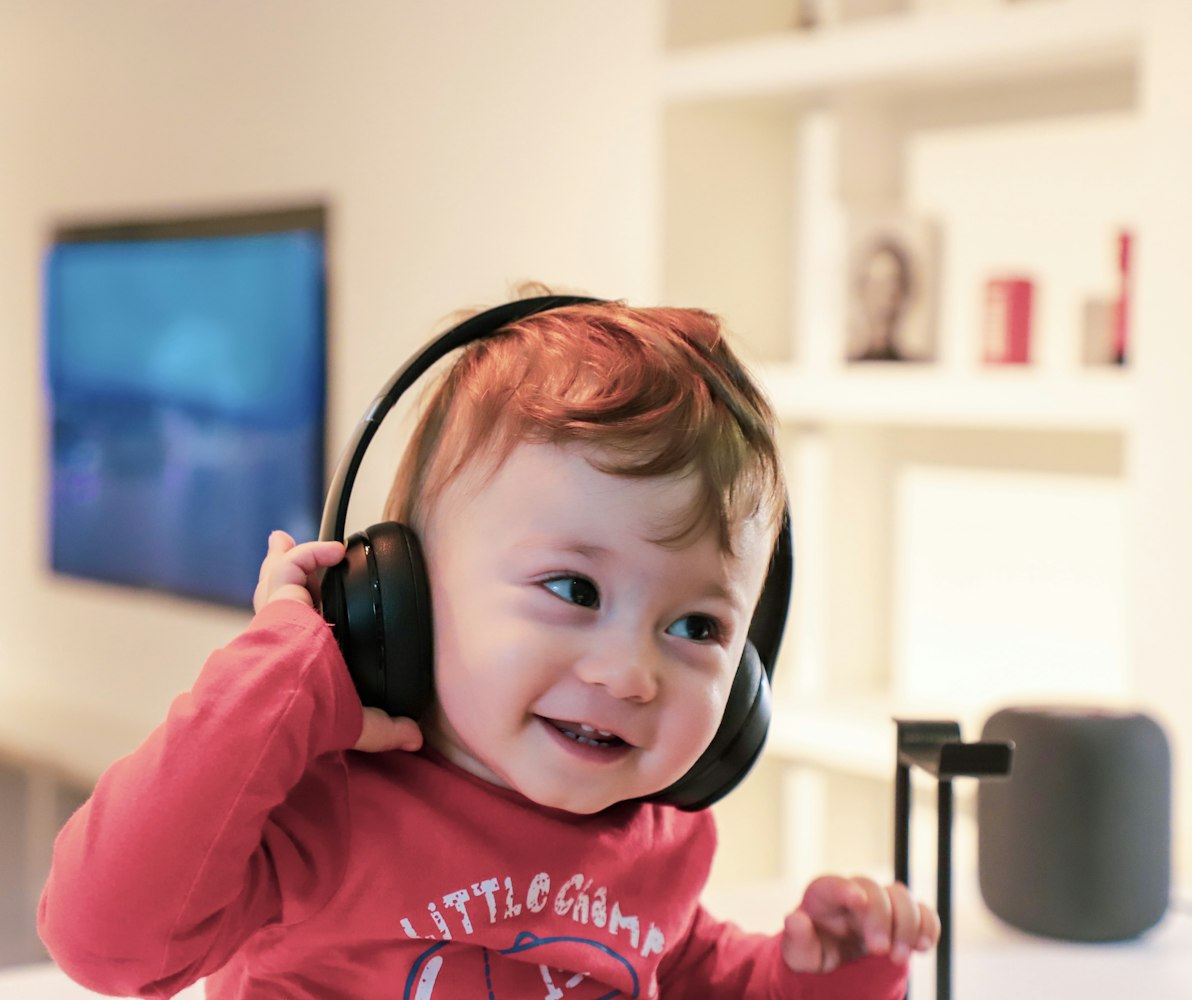 Baby listening in a black headset