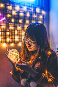 A Roblox-inspired avatar holding a glowing lightbulb surrounded by playful shapes.