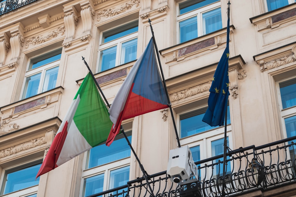 three flags waving on balcony