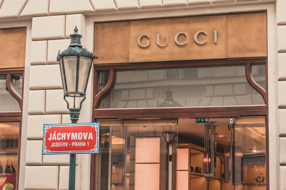 light sconce beside Gucci building signage at daytime