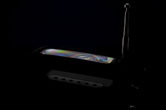 Close-up of a sleek RF wideband receiver with glowing interface panels.