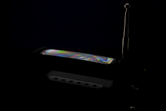 Close-up of a sleek satellite decoder with LED indicators glowing softly