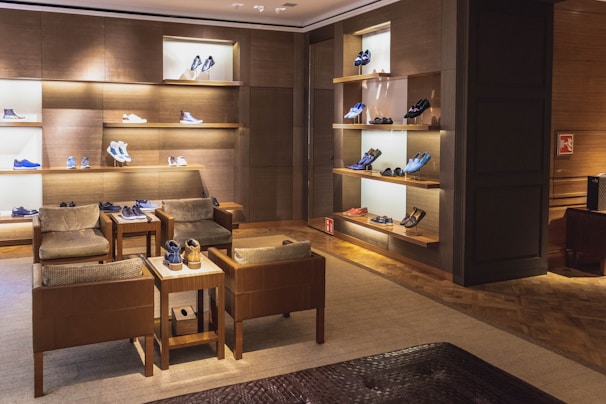 A cozy shoe store interior with neatly arranged footwear and warm lighting inviting customers inside.
