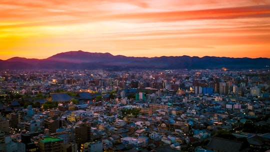 aerial photography of concrete buildings at golden hour in Kyoto Tower Japan