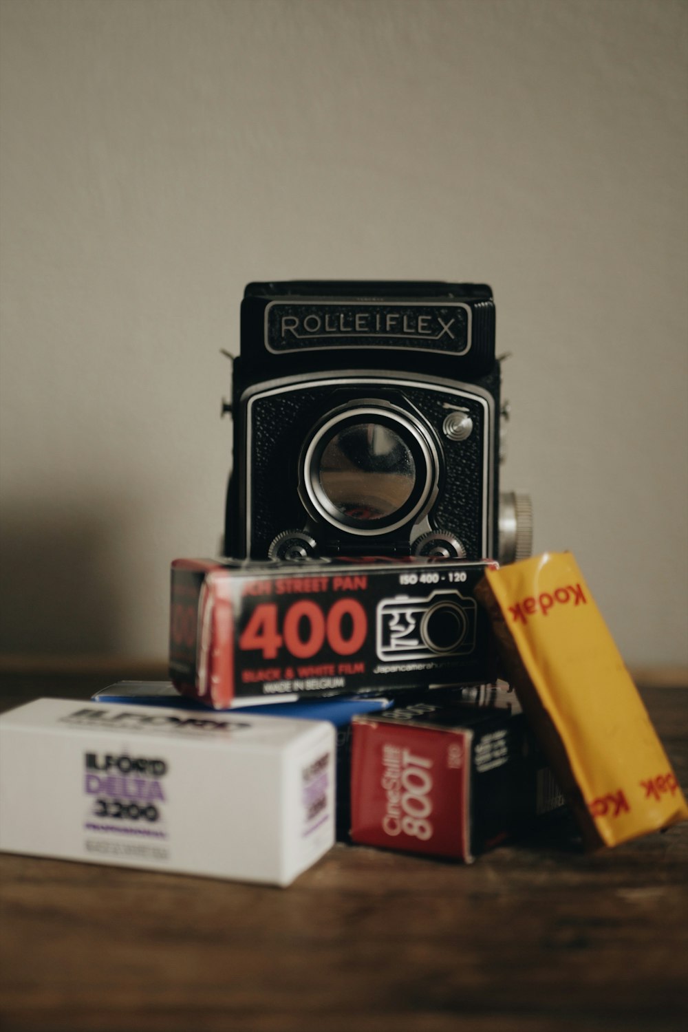 black Rolleiflex camera near boxes