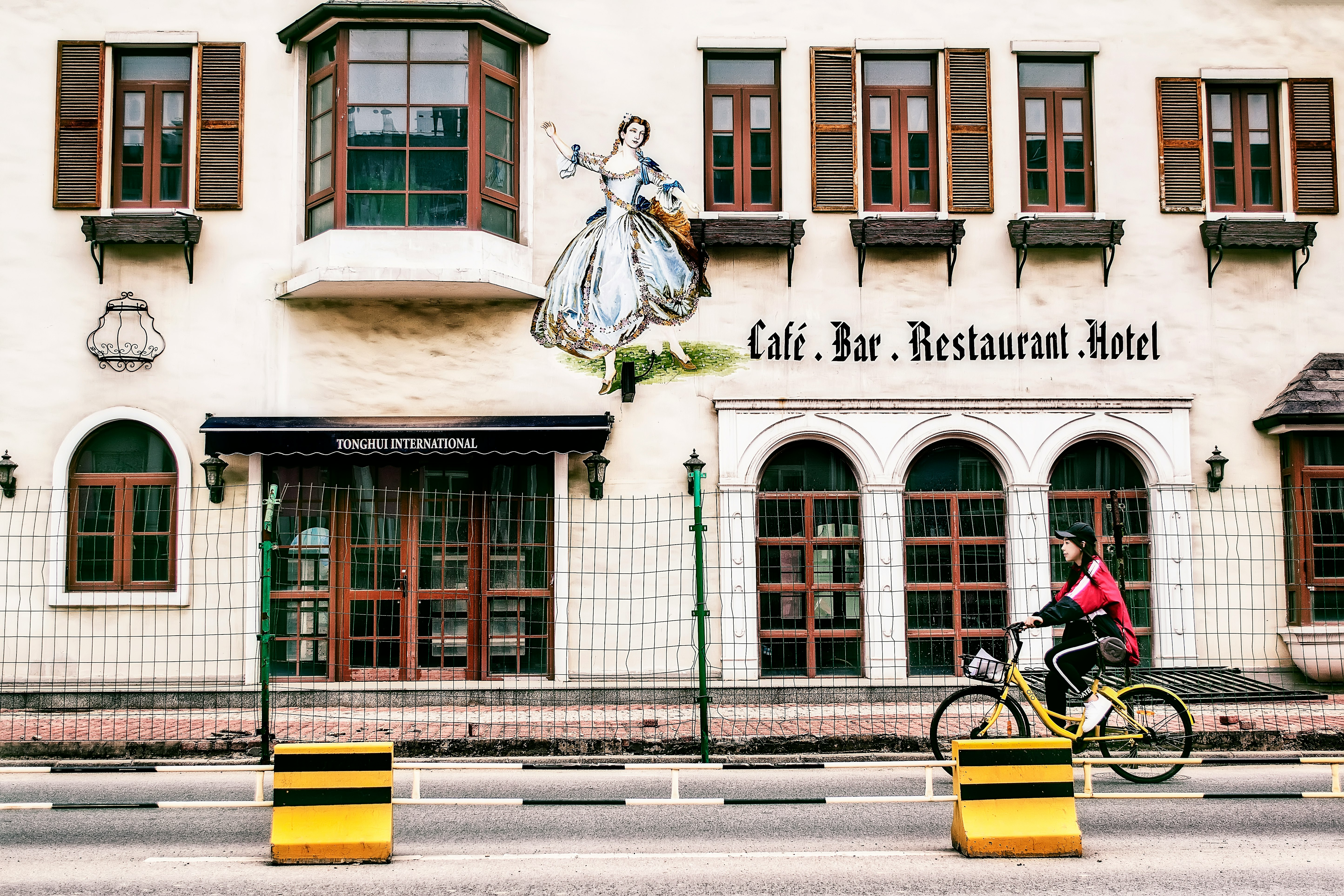 woman using yellow and black cruiser bicycle during daytime