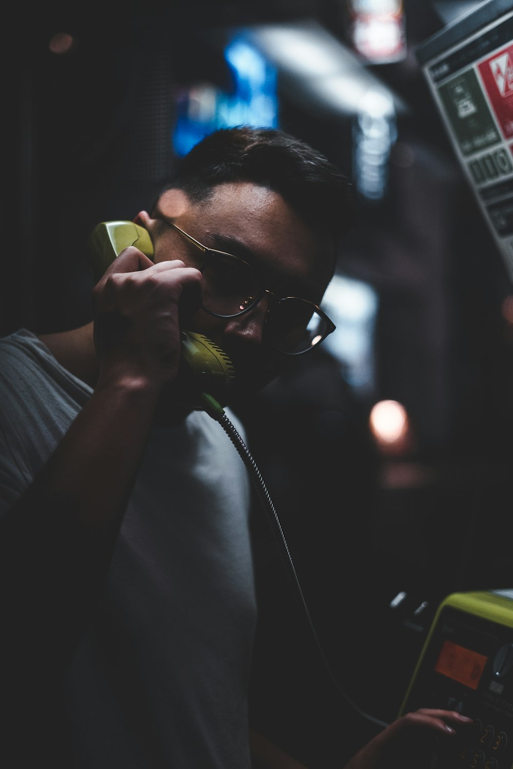 man standing holding telephone