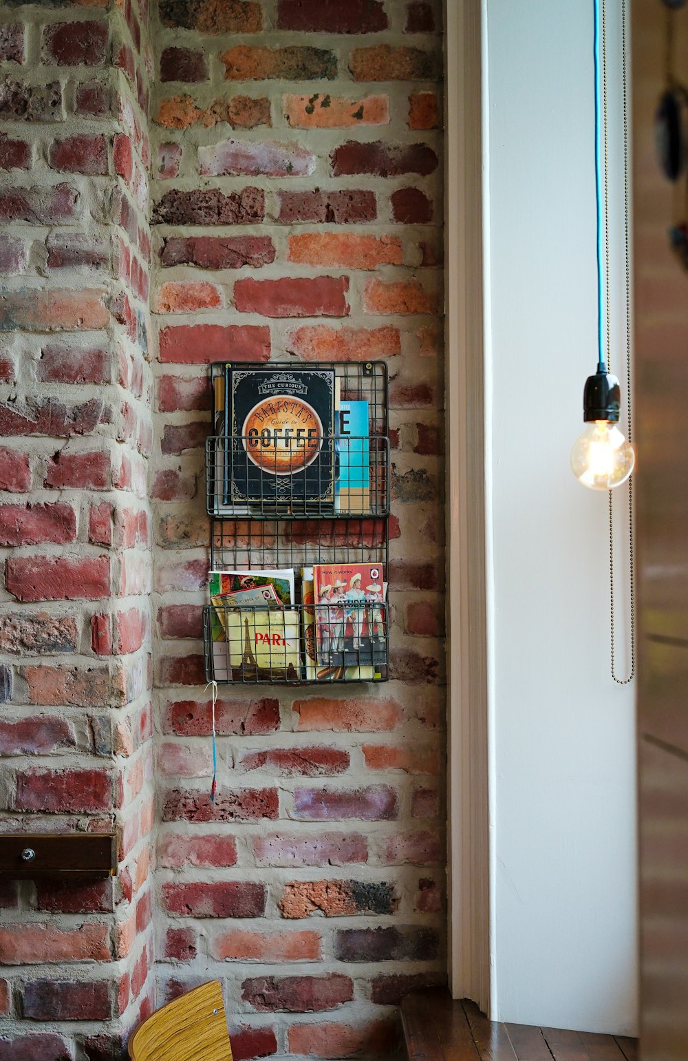 assorted magazines on gray metal wall rack