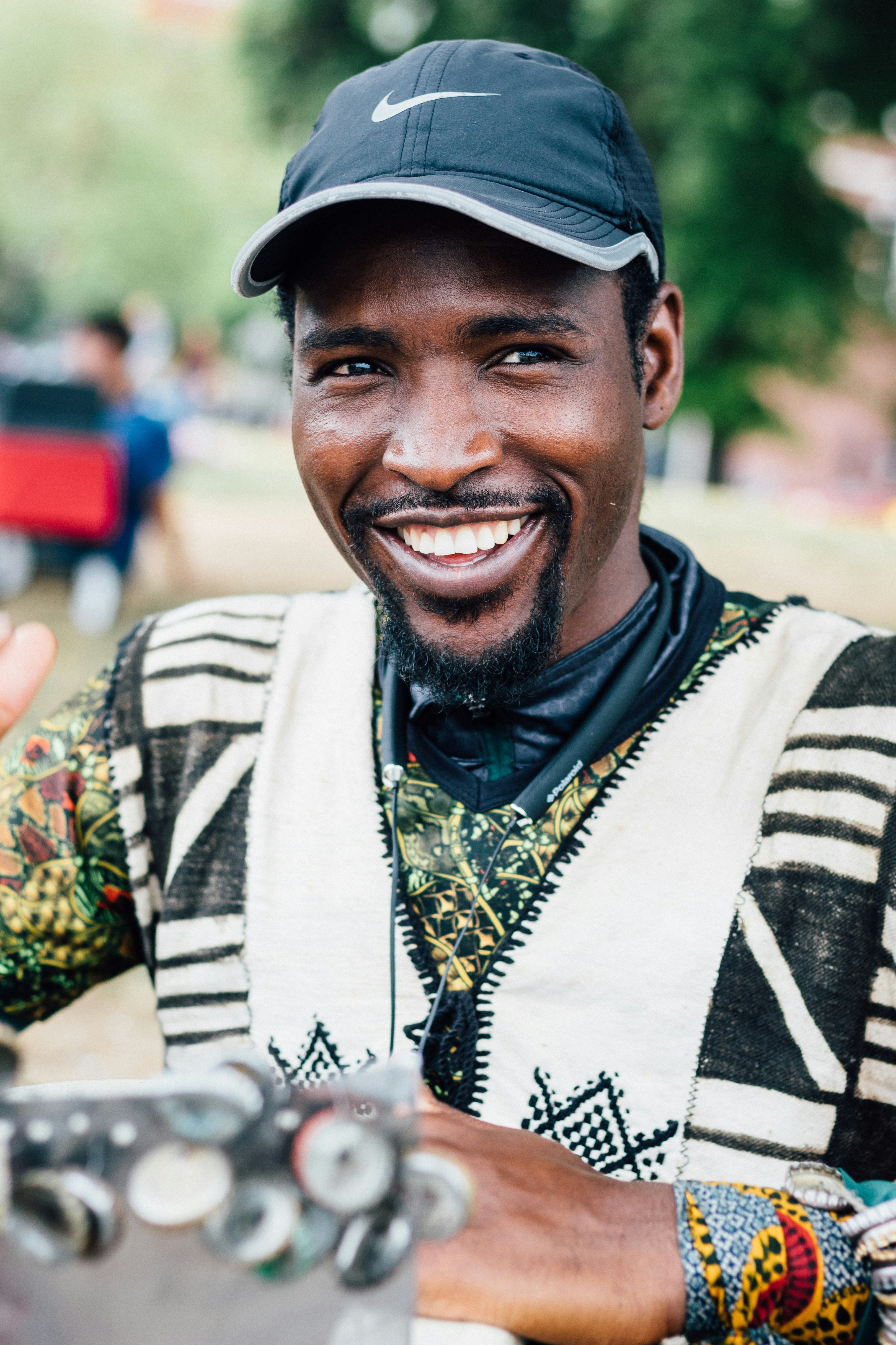 smiling man wearing black Nike baseball cap