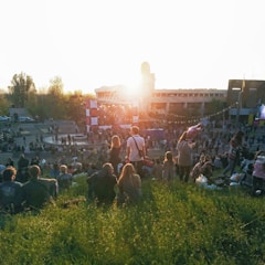 Crowd waiting outside a popular event venue during sunset.