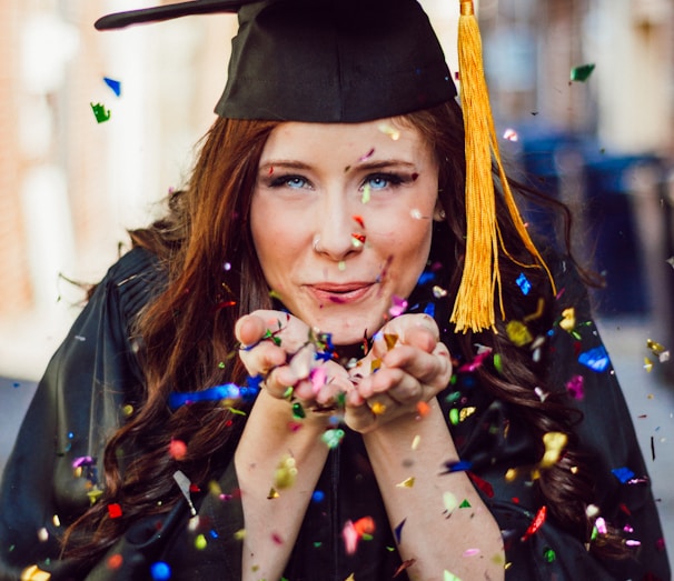 woman blowing assorted color confettis