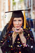 woman blowing assorted color confettis